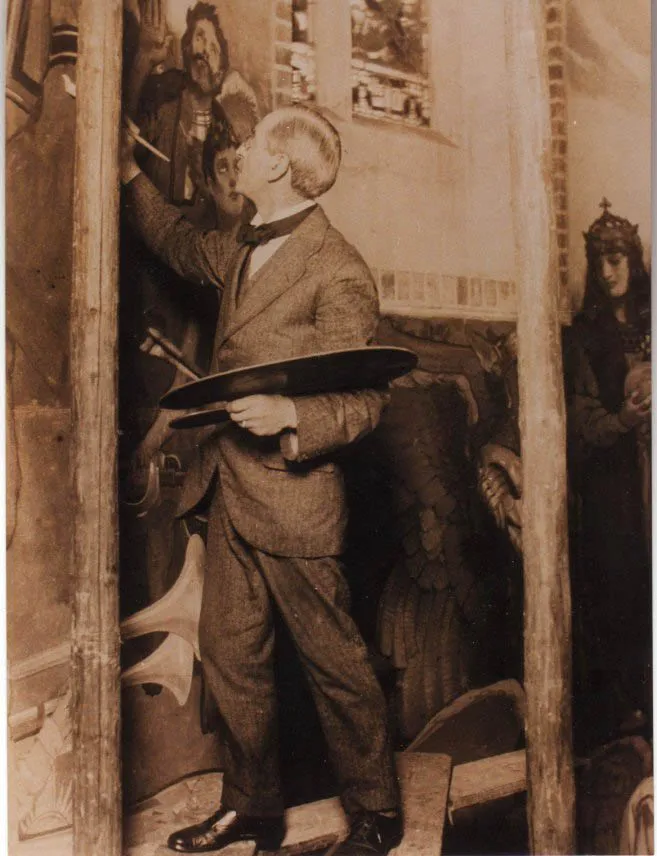 The artist James Clark in his studio, painting one of the tall canvas strips that make up the apse painting.