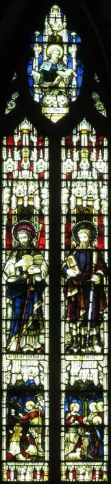 One of the stained-glass windows above the high altar, showing two standing saints.