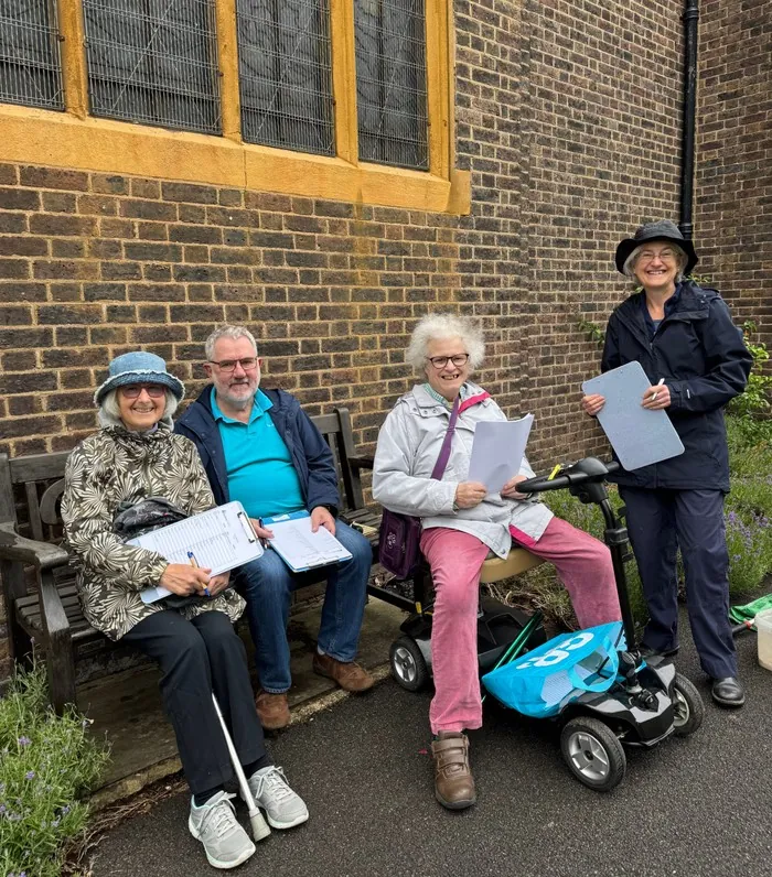 Four volunteers pose with clipboards outside for the Churches Nature Count
